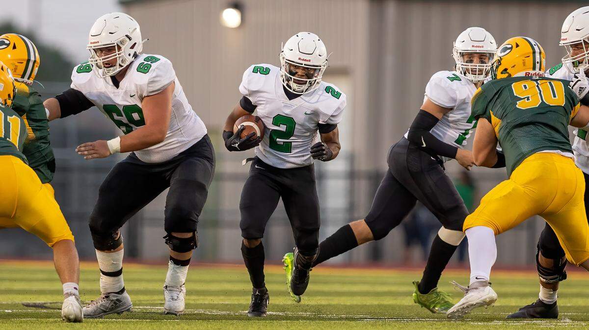 Derby running back Dylan Edwards runs through a hole against Bishop Carroll in a 45-38 victory on Friday.