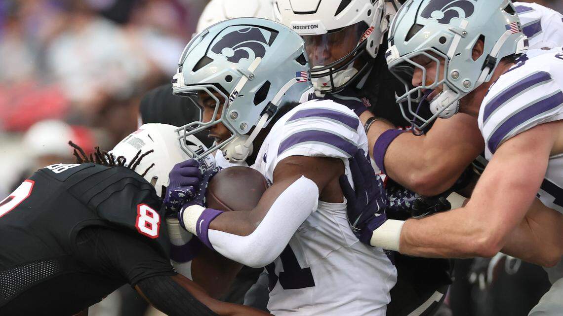 Kansas State Wildcats running back DJ Giddens (31) is tackled by Houston Cougars defensive back Kentrell Webb (8) in the first quarter at TDECU Stadium.