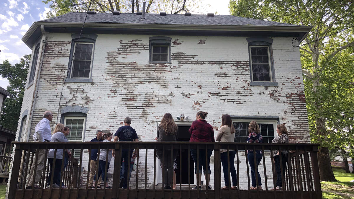 A tour group stands on the back porch of the Sallie House in Atchinson, Kansas.