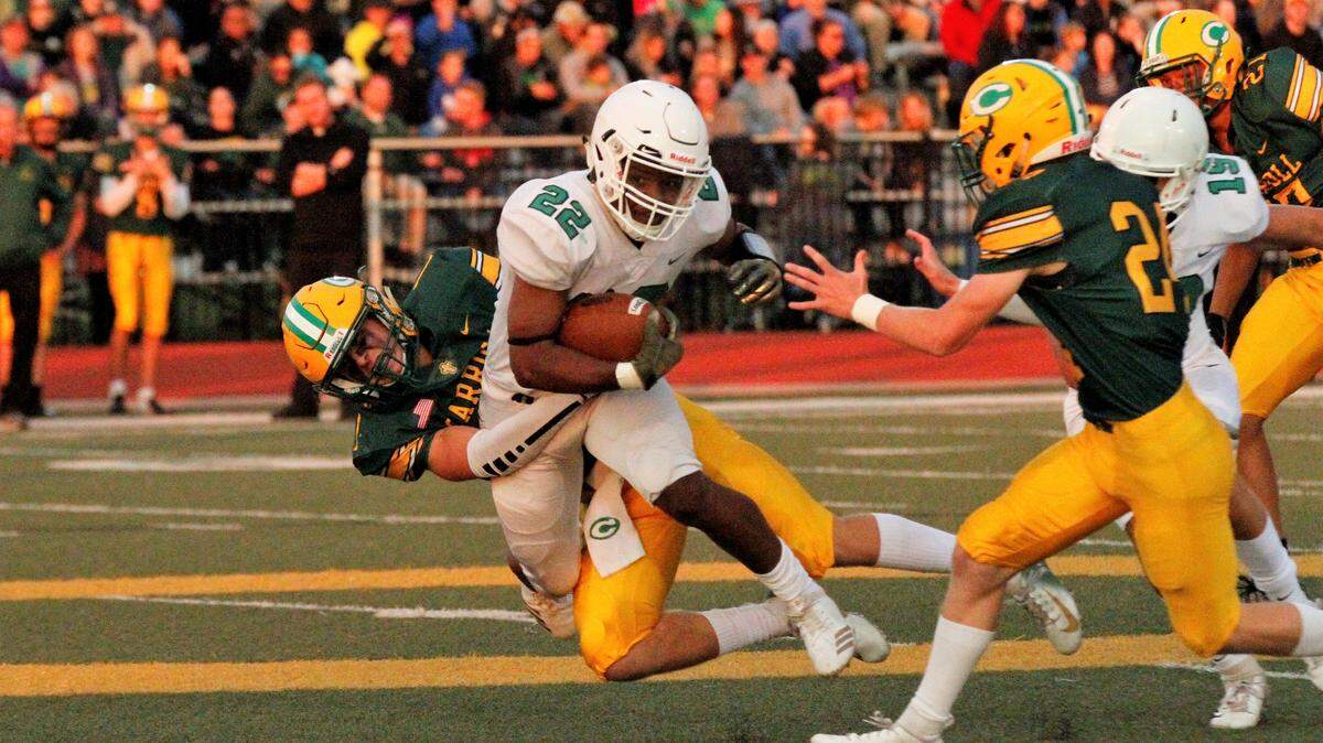 Derby junior running back Tre Washington gets tackled during the Panthers’ 26-4 win at Bishop Carroll on Friday. (Sept. 21, 2018)