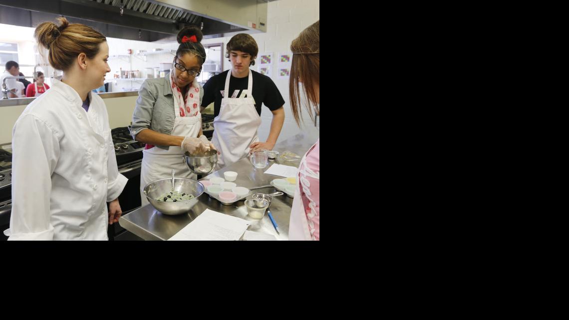 West High culinary arts teacher Katie Geringer, left, works with students Celasha Jones and Chandler Sandusky in the Culinary Essentials class in the school’s new culinary arts room. (Feb. 27, 2014)


