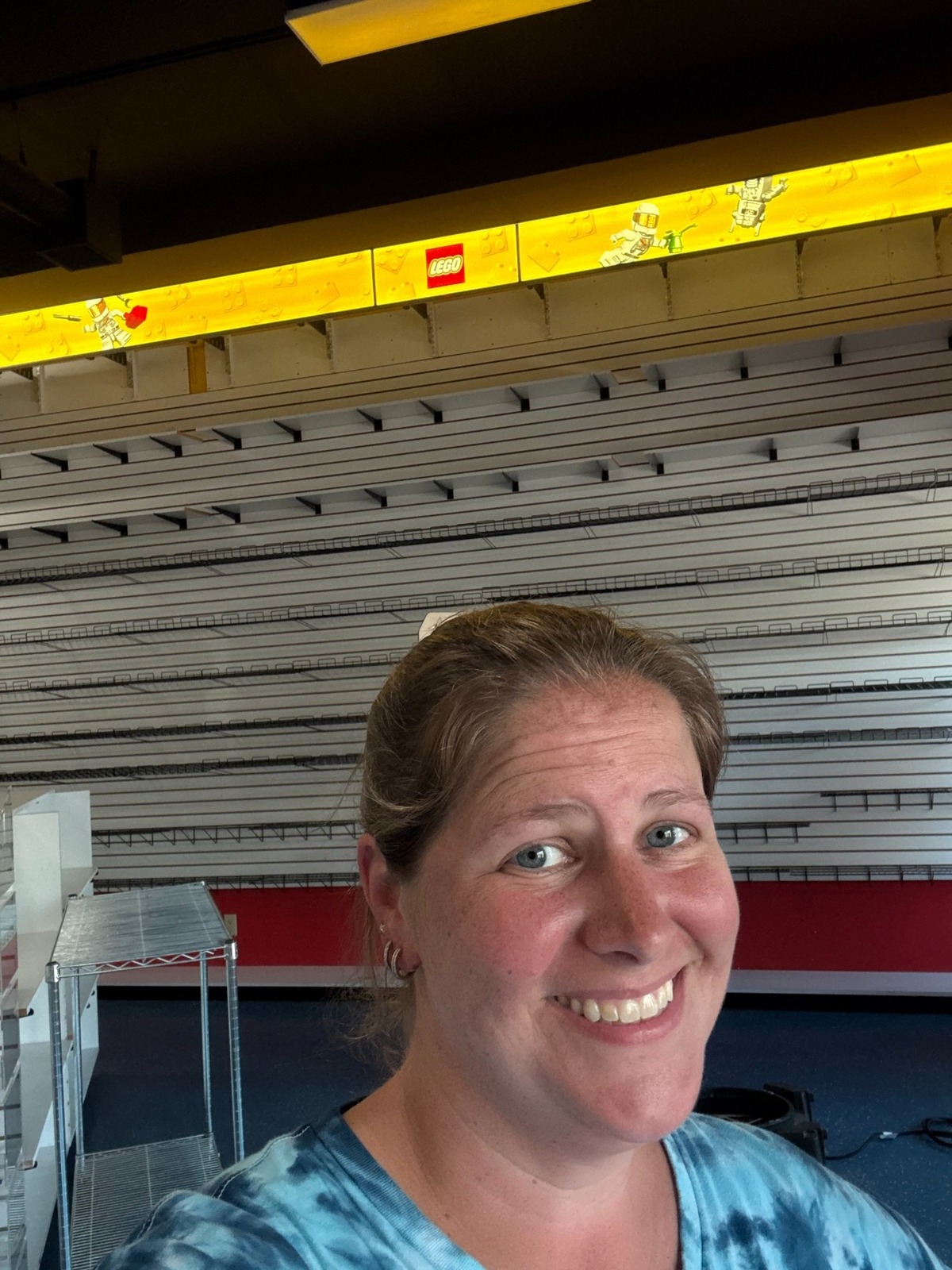Imagine That Toys owner Gwen Ottenberg, who said she’s hot and sweaty in this photo due to a lack of air conditioning, is putting on a positive face amid trying to reopen the store following smoke damage from a nearby fire.