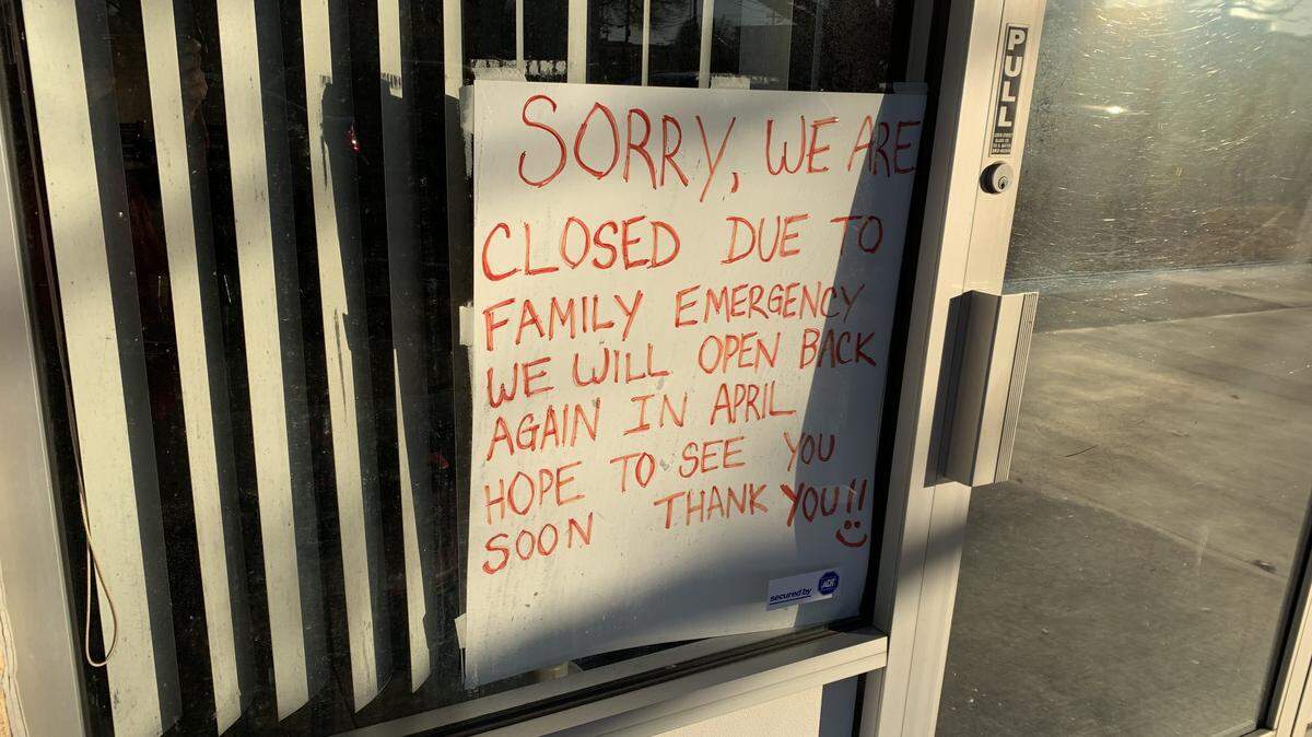A sign in the window lets customers know that My Tho will be closed until April.