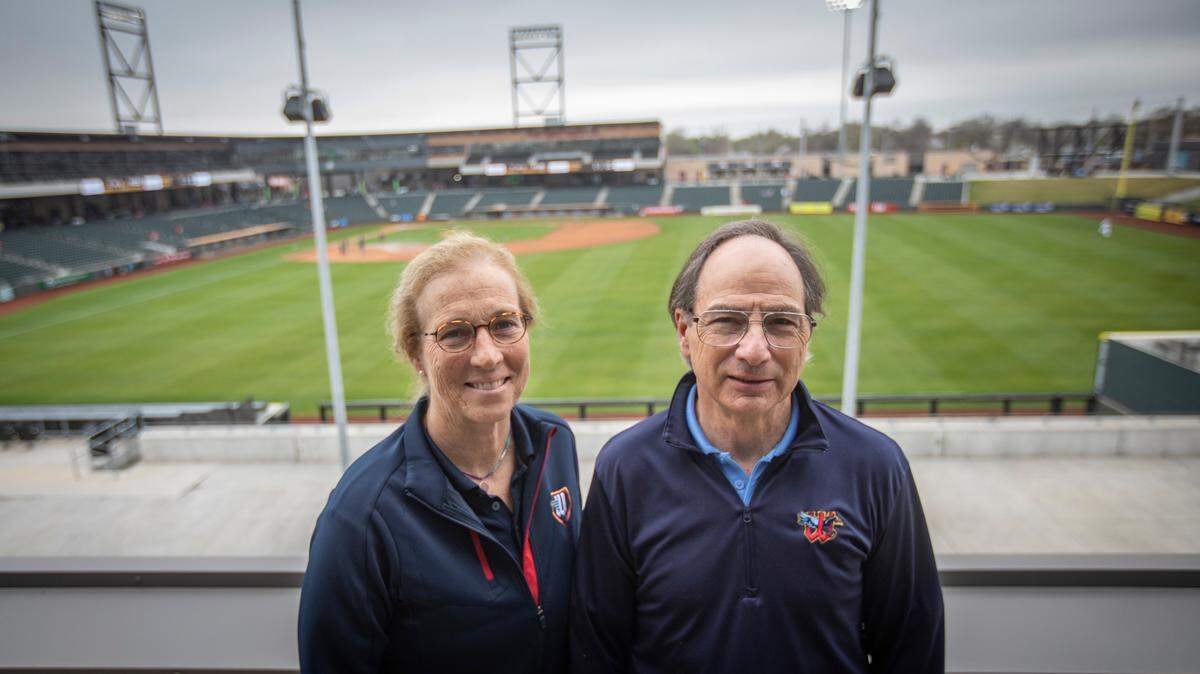 Wichita Wind Surge partners Jane Schwechheimer and Jordan Kobritz are pictured before a recent day game at Riverfront Stadium. Kobritz, CEO, and Schwechheimer are leading the ball club since the 2020 COVID-19 death of Lou Schwechheimer, Jane Schwechheimer’s husband and the team’s founder.