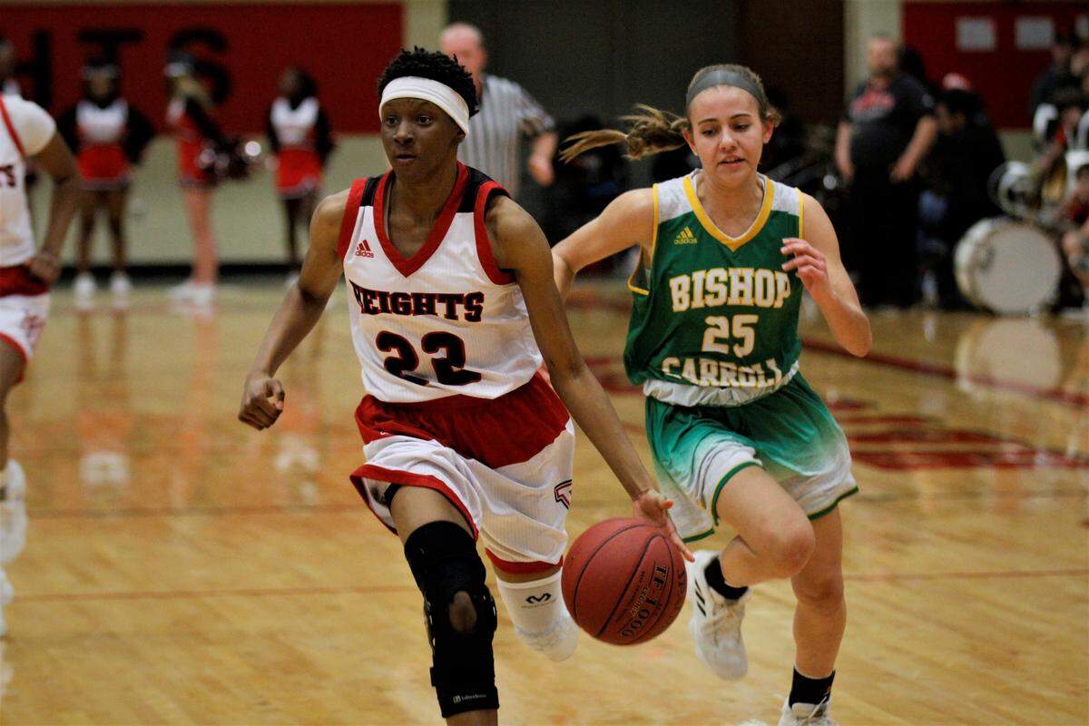 Wichita Heights’ Derryana Cobbins runs a fastbreak with Bishop Carroll’s Kendall Forbes trailing during the Falcons’ 45-35 win over the Golden Eagles on Tuesday night. (Jan. 8, 2019)