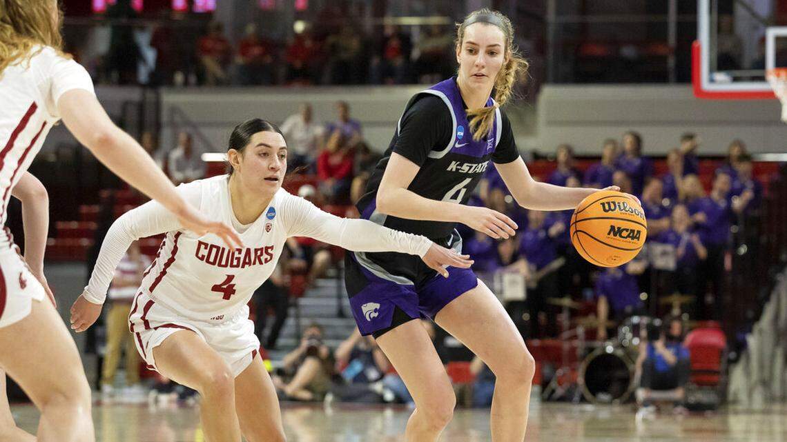 Kansas State’s Serena Sundell, right, handles the ball as Washington State’s Krystal Leger- Walker, left, defends during the first half of a college basketball game in the first round of the NCAA tournament in Raleigh, N.C., Saturday, March 19, 2022. (AP Photo/Ben McKeown)