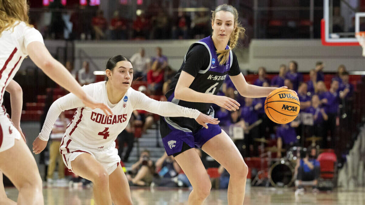 Kansas State’s Serena Sundell, right, handles the ball as Washington State’s Krystal Leger- Walker, left, defends during the first half of a college basketball game in the first round of the NCAA tournament in Raleigh, N.C., Saturday, March 19, 2022. (AP Photo/Ben McKeown)
