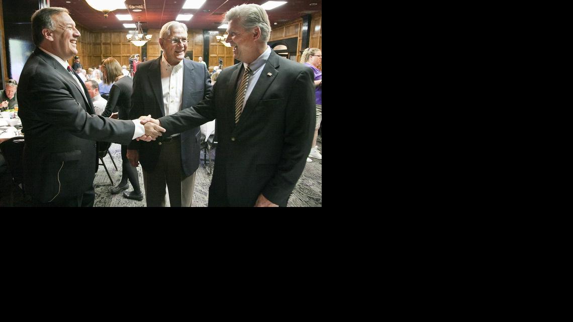 Fourth District GOP candidates Mike Pompeo, left, and Todd Tiahrt prepare to debate recently at a Wichita Crime Commission luncheon. Paul Longhoffer, center, was moderator. 

