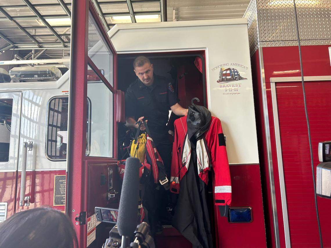 Tyler Brenneman shows media a swift water drysuit. Suits like this were used to help with Hurricane Helene relief efforts.