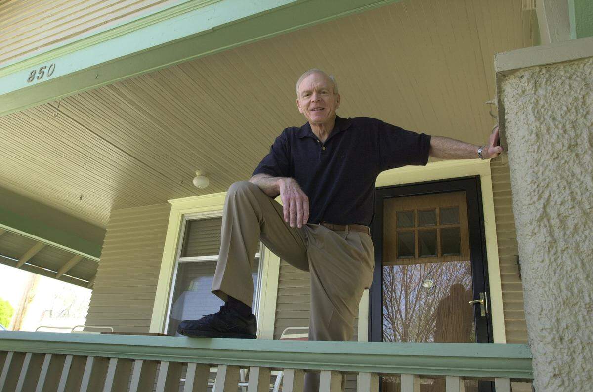 In this 2003 file photo, Martin Eby Jr. stands on the porch of his boyhood home at the southeast corner of Franklin and Litchfield in Riverside, where his parents started Eby Construction at their kitchen table.