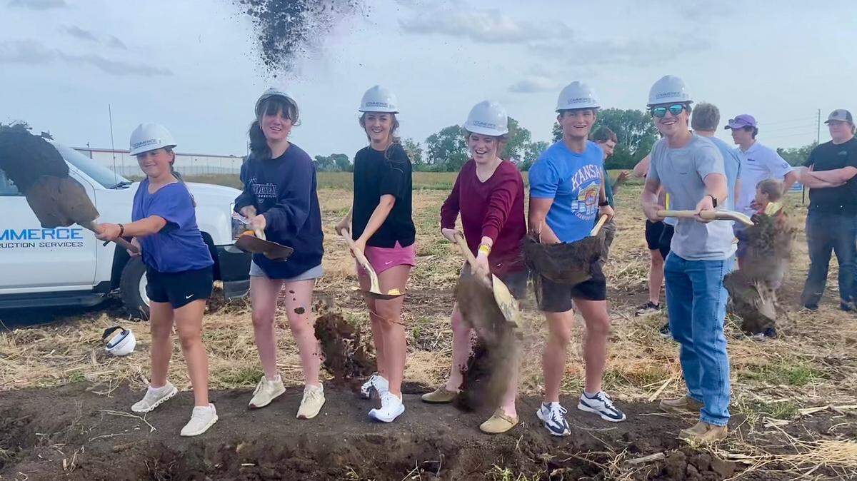 A variety of people, including the students shown here, participated in a Sunday groundbreaking in Maize where Metropolitan Baptist Church is building its new church in two phases.