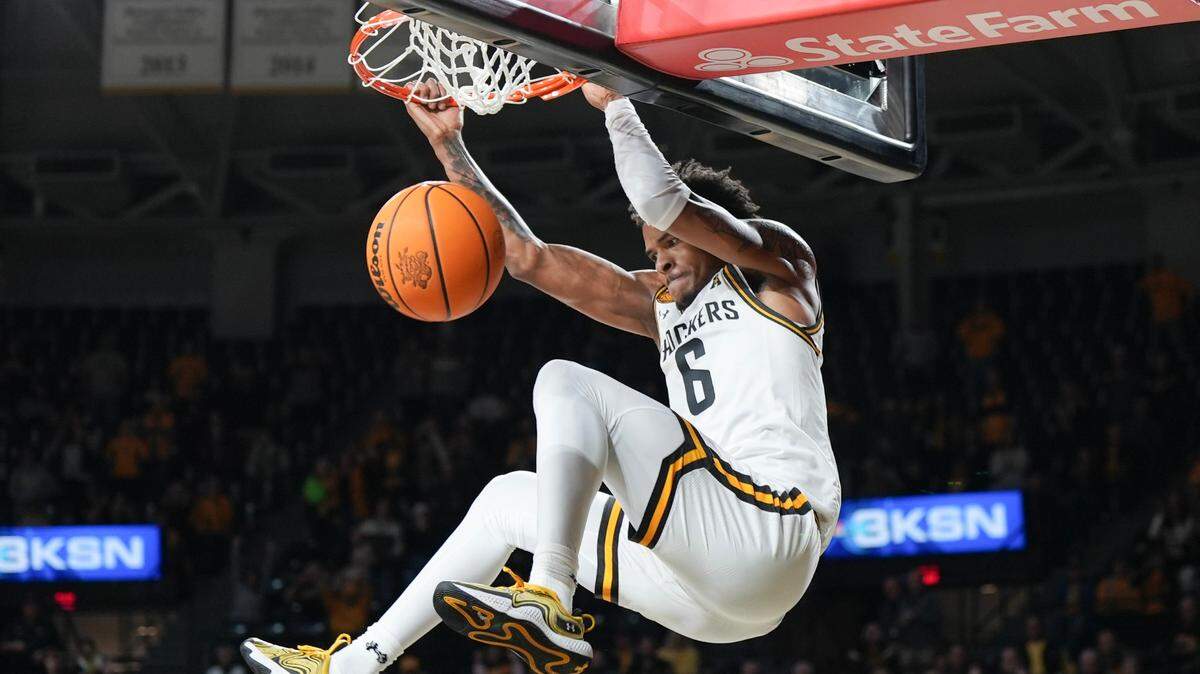 Wichita State University’s Corey Washington with a slam dunk in the second half against Monmouth at Koch Arena.
