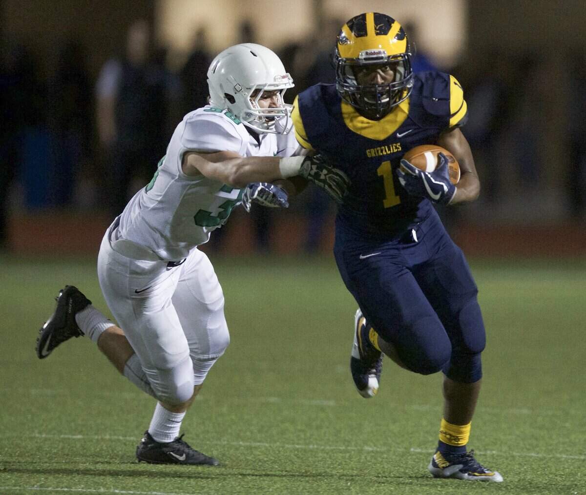 Wichita Northwest’s Breece Hall tries to escape the tackle of Derby’s Jacob Ormsby during the second quarter of their semi-final game at Northwest.