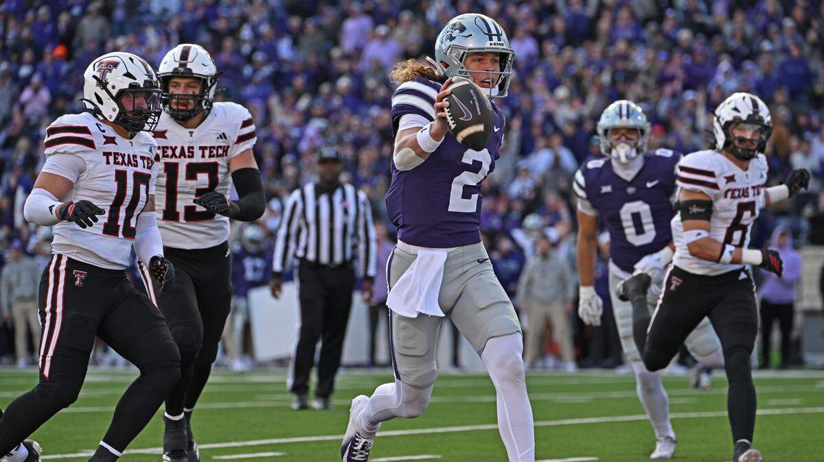Quarterback Avery Johnson #2 of the Kansas State Wildcats scores a touchdown past safety Logan Bartley #10 of the Kansas State Wildcats in the second half at Bill Snyder Family Football Stadium on November 1, 2025 in Manhattan, Kansas.