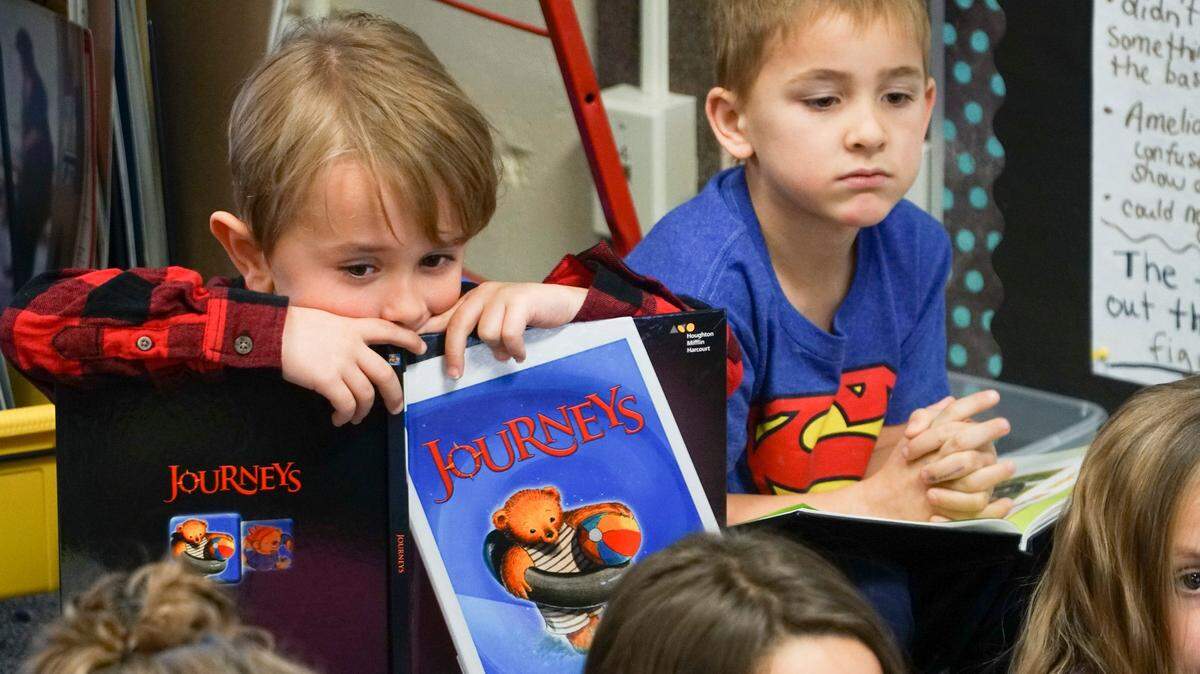 Braxton Law holds his textbook in his kindergarten class at Peterson Elementary in December 2017. His teacher, Holly Morgan, piloted a new reading program that Wichita elementary schools will launch this year. The program is aimed at helping teachers tailor lessons to a wider variety of students.