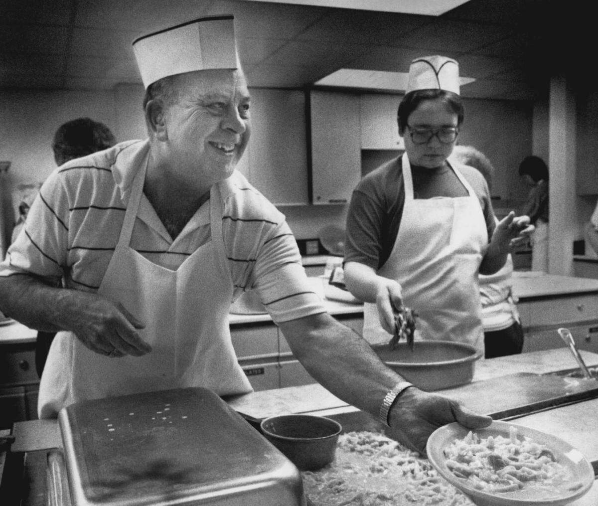 A photo published in 1989 shows St. Paul’s Chicken Noodle Dinner volunteer Wayne Wernecke as he distributes dinners at the fundraiser.