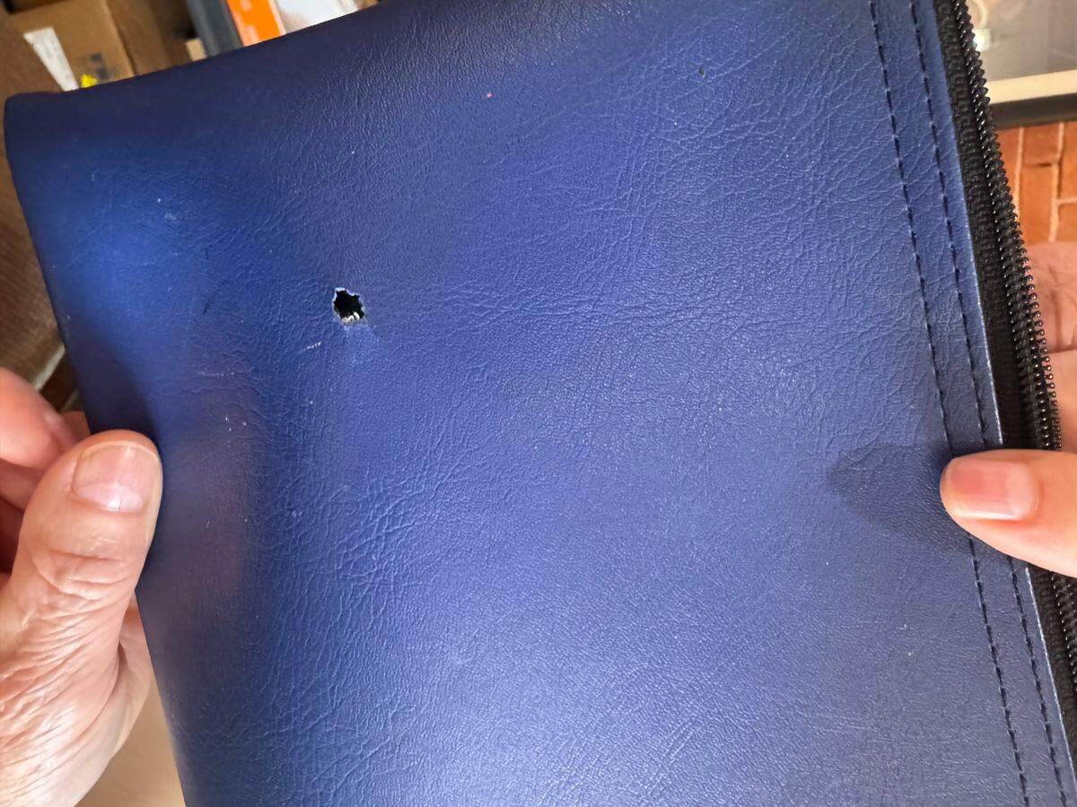 Ruben Acosta still has the bank pouch that robber Reginald Kane was holding when he was hit by return fire from Acosta.