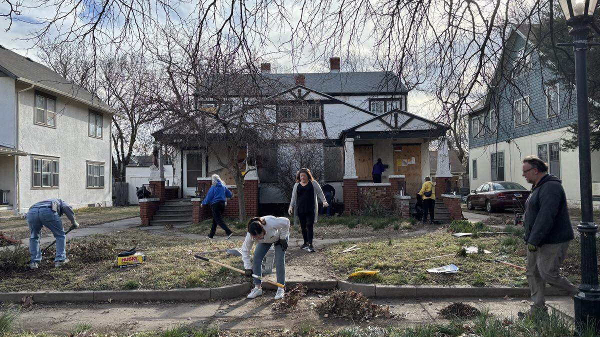 Volunteers work to clean the property at 1416 and 1418 N. Park Place. The Historic Midtown Community Development Association is working to save the 1923 arts-and-crafts style duplex.
