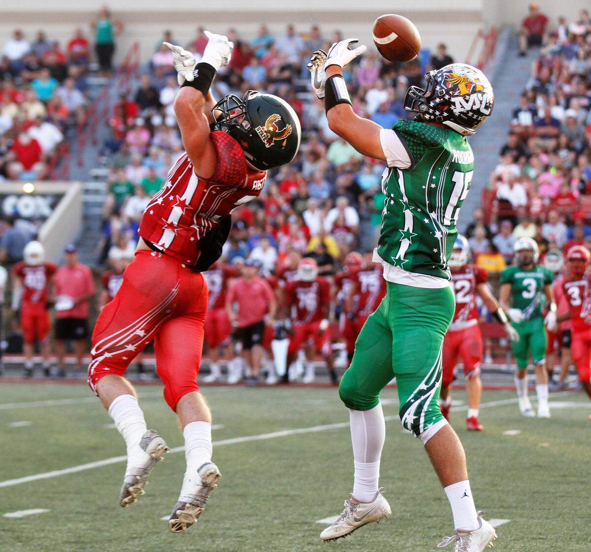 Free State defensive back Gage Foster (left) and Holcomb receiver Chance Rodriguez (right) battle for a pass during the 2018 Kansas Shrine Bowl at Carnie Smith Stadium in Pittsburg, Kansas. The East beat the West 21-14. (July 28, 2018)
