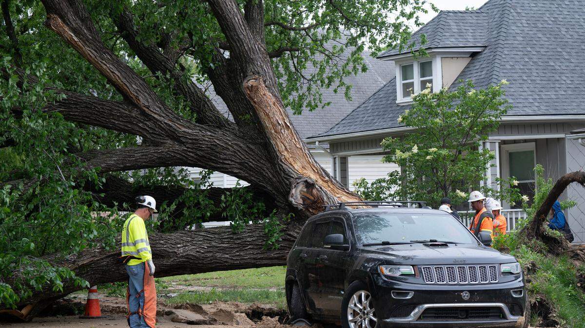 A car is pulled from a large sinkhole it fell into after a water main break at Market and Morris on Monday. Part of Market was temporarily closed as crews from Wichita’s public works department removed the tree and repaired the water line.