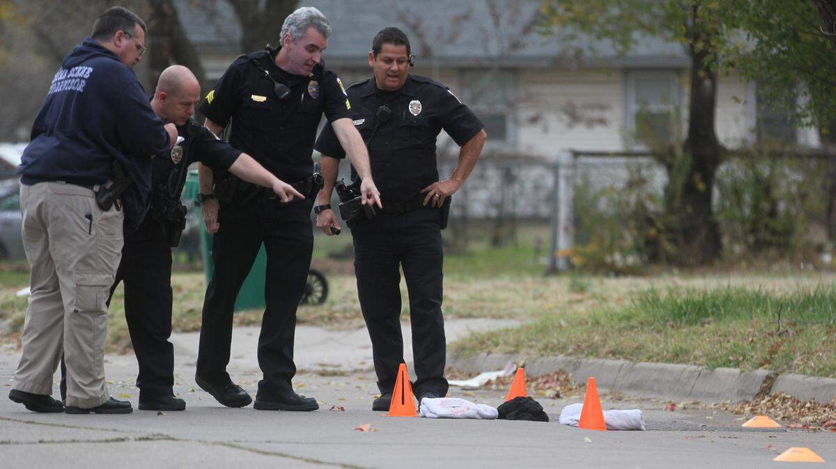 Police point to the ground in a north Wichita neighborhood where a man was found with multiple gunshot wounds on Wednesday.