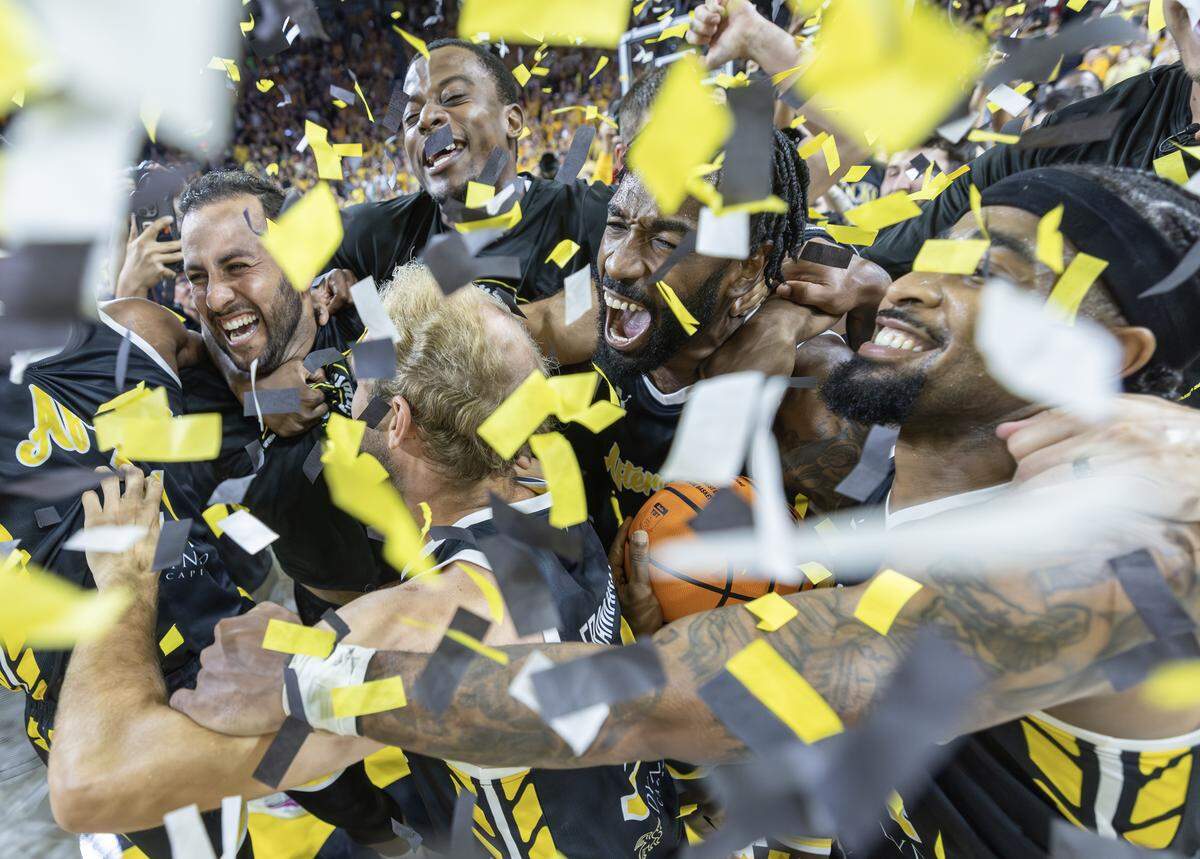 The Aftershocks celebrate amongst confetti after they beat Eberlein Drive to win the million dollar TBT championship on Sunday at Koch Arena.