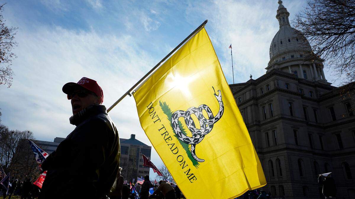The Gadsden Flag, pictured here in the hands of a Minnesota protester, will likely soon be available as an option on Kansas license plates.