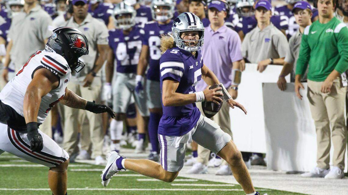 Kansas State Wildcats quarterback Avery Johnson (5) tries to run away from Southeast Missouri State Redhawks defensive lineman Steven Lewis (99) during the fourth quarter at Bill Snyder Family Football Stadium on Sept. 2, 2023.