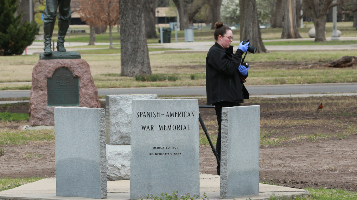 A crime scene investigator takes a photo and collects evidence after a cannon was stolen from the Spanish-American War monument in Central Riverside Park. The cannon was later recovered with significant damage.