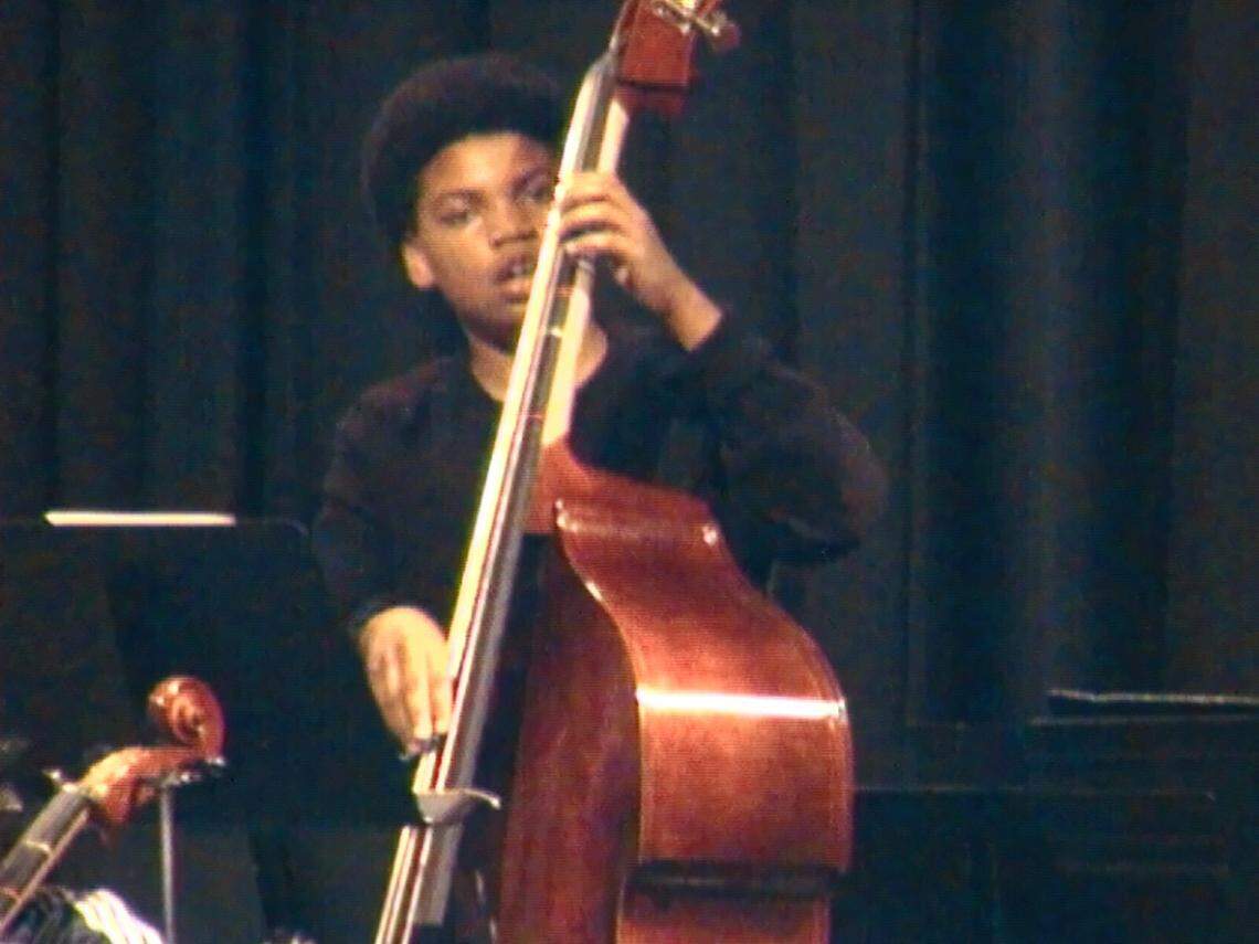 Marcus Hicks, 11, plays the bass during a performance. Saturday, Hicks will play in the Kansas high school football Class 5A state championship game.
