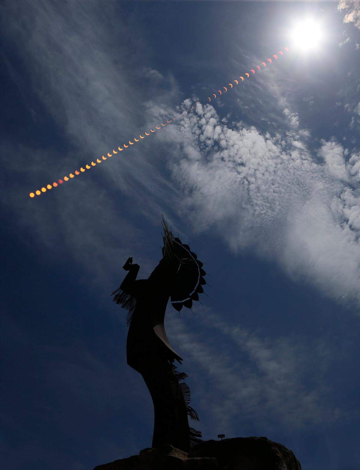 A partial eclipse of the sun fills the sky over The Keeper of the Plains on August 21, 2017. The photo is comprised images taken every three minutes throughout the eclipse.