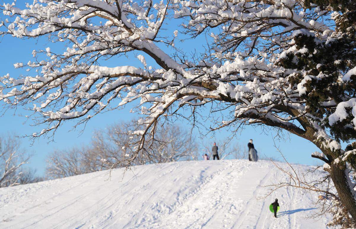 Early morning sledders were the first one on the hill around 8 a.m. at Sedgwick County Park. About six inches of snow fell on Wichita late Thursday evening.