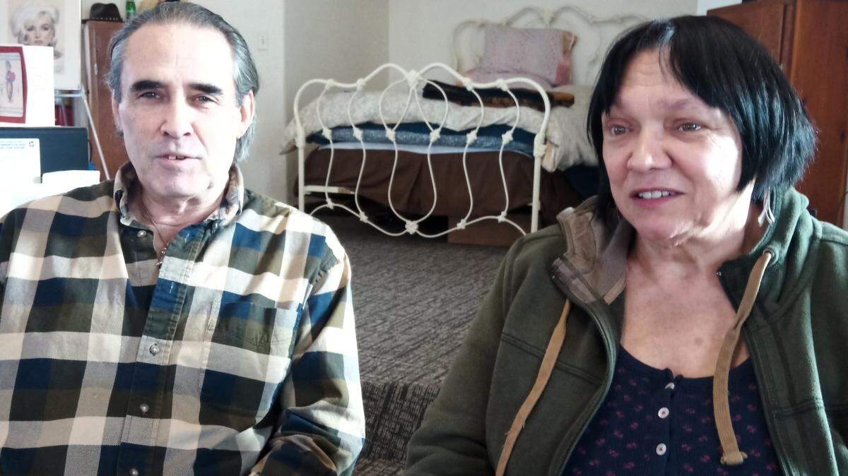 Dorothy Tobe tears up while talking about life in St. John since she and her husband Mike Rosseau moved there. Behind them is the bed they haven’t been able to sleep in since July because of zoning issues.