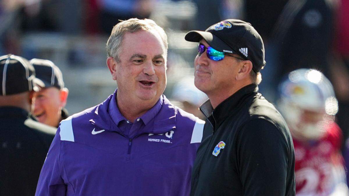 TCU Horned Frogs head coach Sonny Dykes talks with Kansas Jayhawks head coach Lance Leipold talk prior to a game at David Booth Kansas Memorial Stadium.