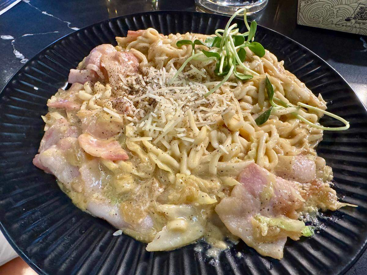 Gyoza Bar offers several udon noodle dishes made with cream sauce. This one is a take on carbonara.