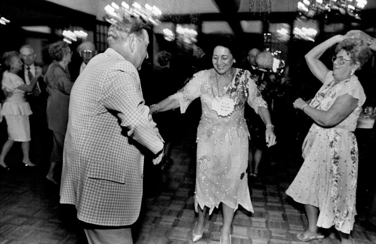 People attending dancing at a high school reunion at The Petroleum Club in 1990