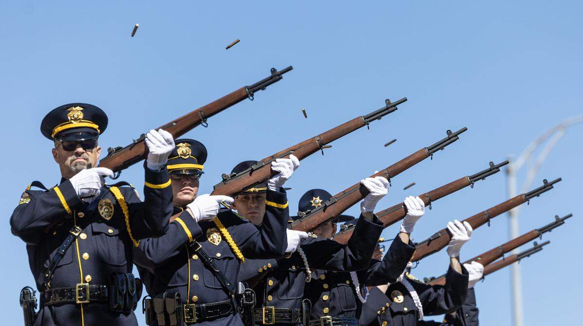 A law enforcement honor guard fires off a 21-gun salute near the conclusion of a ceremony outside of City Hall to honor all Wichita and Sedgwick County law enforcement officers that have died in the line of duty.