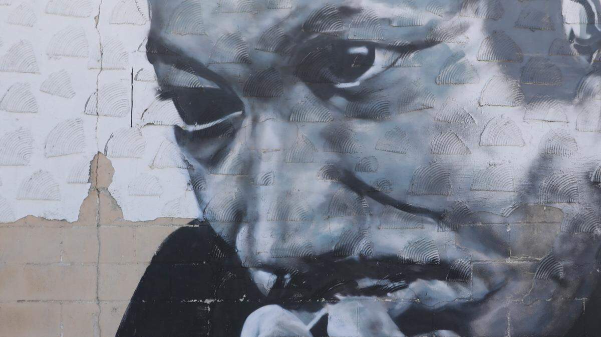A mural of Dr. Martin Luther King Jr. by Wichita artist Daniel Guatimea. The spray painted mural is on the north side of a building across the street from the Historic Dunbar Theatre at Ninth and Cleveland. (January 13, 2021)