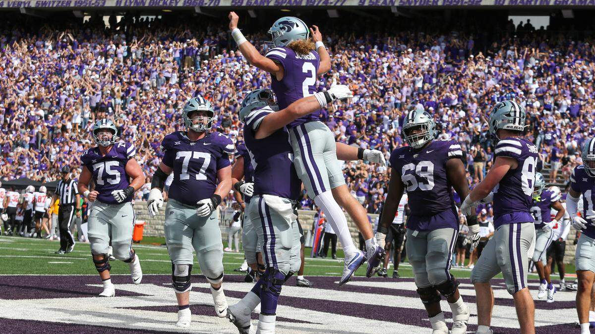 Kansas State Wildcats quarterback Avery Johnson leaps into the arms of offensive lineman Hadley Panzer after scoring a touchdown against the Oklahoma State Cowboys in the fourth quarter at Bill Snyder Family Football Stadium on Saturday, September, 28, 2024.