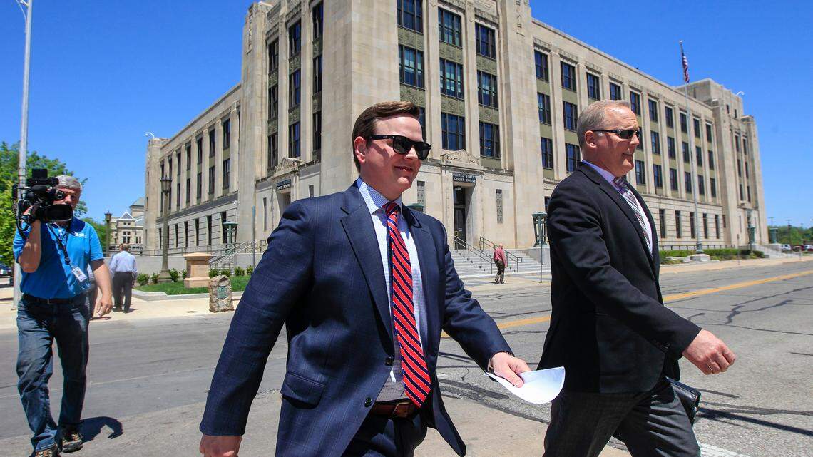 Sedgwick County Commissioner Michael O’Donnell and lawyer Mark Schoenhofer (right) leave the United States Federal Courthouse in downtown Wichita after O’Donnell’s first court appearance in May, when he pleaded not guilty to a variety of charges that include bank fraud and money laundering.