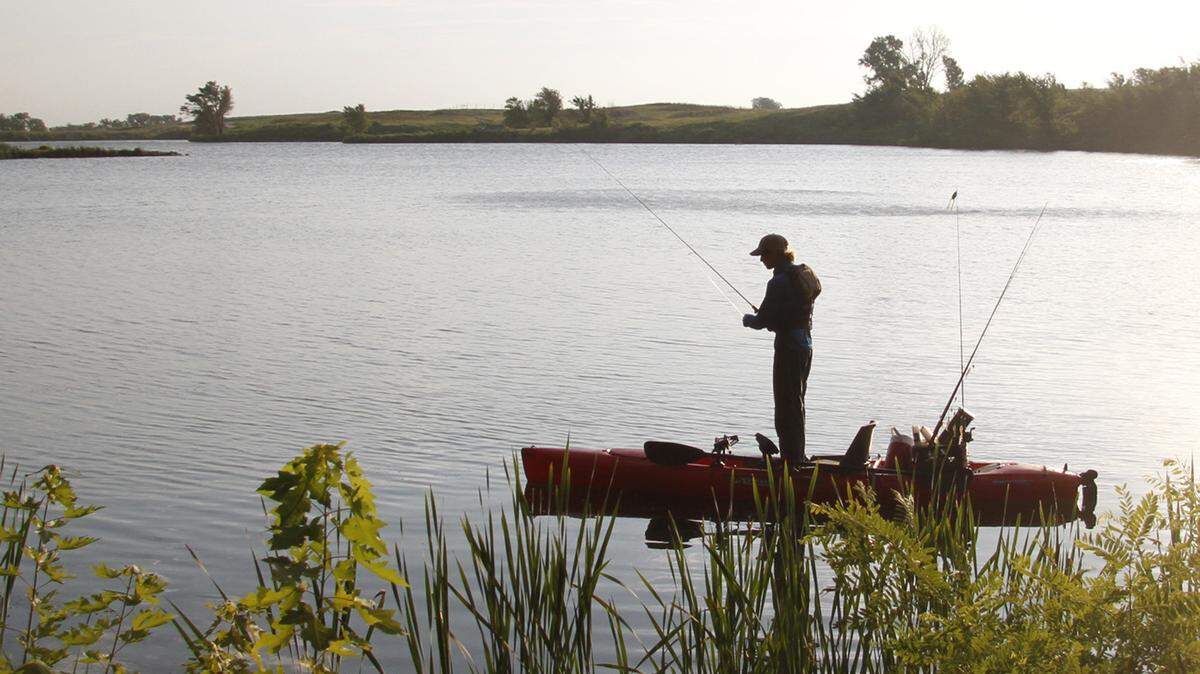 A man fishes from a kayak in this file photo. Here’s what to know if you plan to cast a line in Kansas this summer.