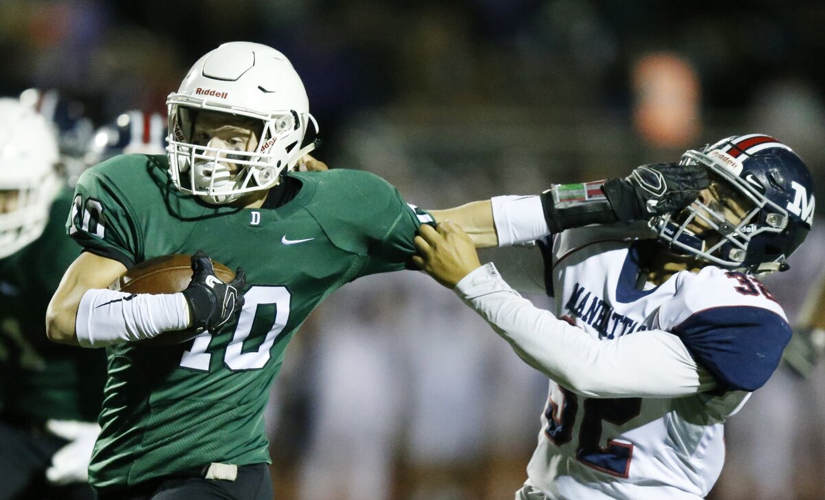Derby’s Dax Benway tries to shake off Manhattan defender#32 BJ Young as he runs for a touchdown late in the first half Friday night in Derby. (November 16, 2018)