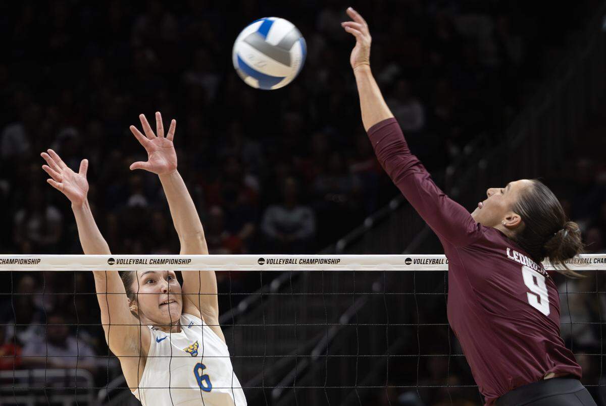 Texas A&M’s Logan Lednicky hits a shot against Pittsburgh’s Sophia Gregoire during their semifinal match of the NCAA Volleyball Championship on Thursday night at the T-Mobile Center.