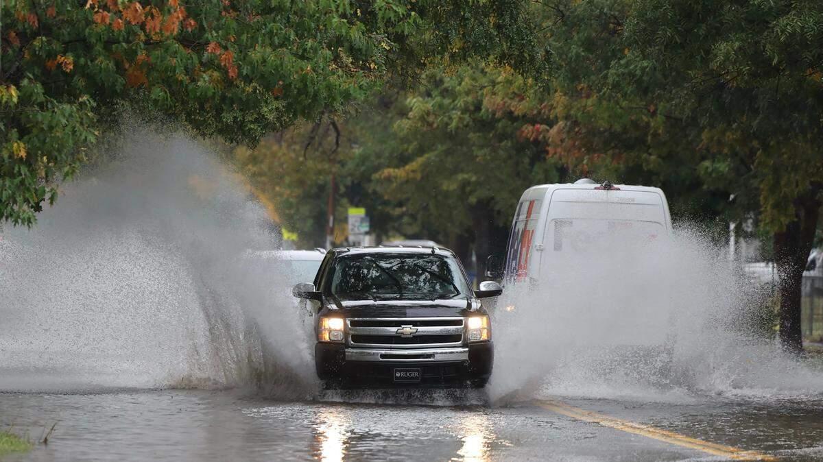 A truck drives through a lot of water on Maple near Seneca on Wednesday.