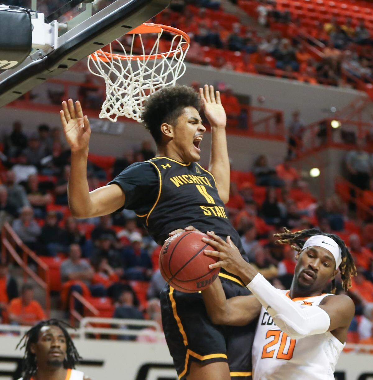 Wichita State’s Kenny Pohto throws down a dunk over Oklahoma State’s Keylan Boone during the second half.