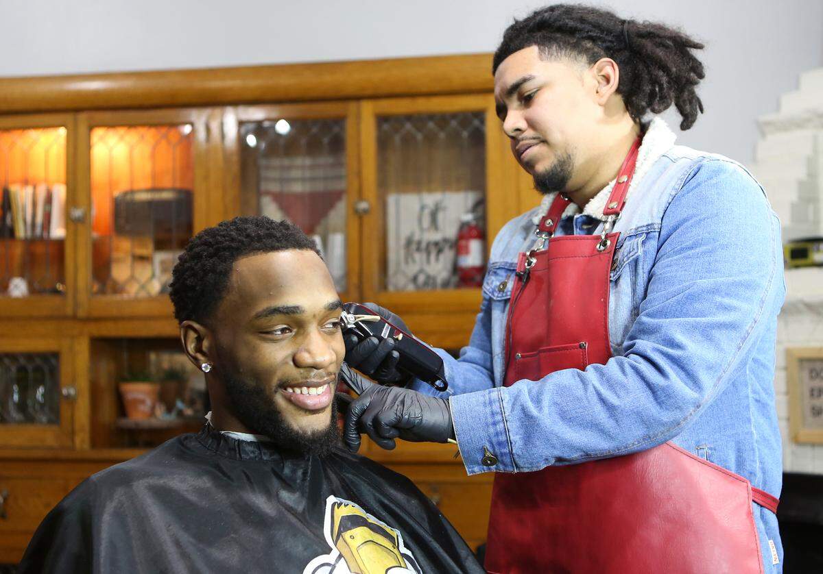 Keyo Sanchez cuts Wichita State basketball player Markis McDuffie’s hair at Tory Brooke Salon. Sanchez has cut the senior’s hair since he was a freshman and the two have been through many different hairstyles.