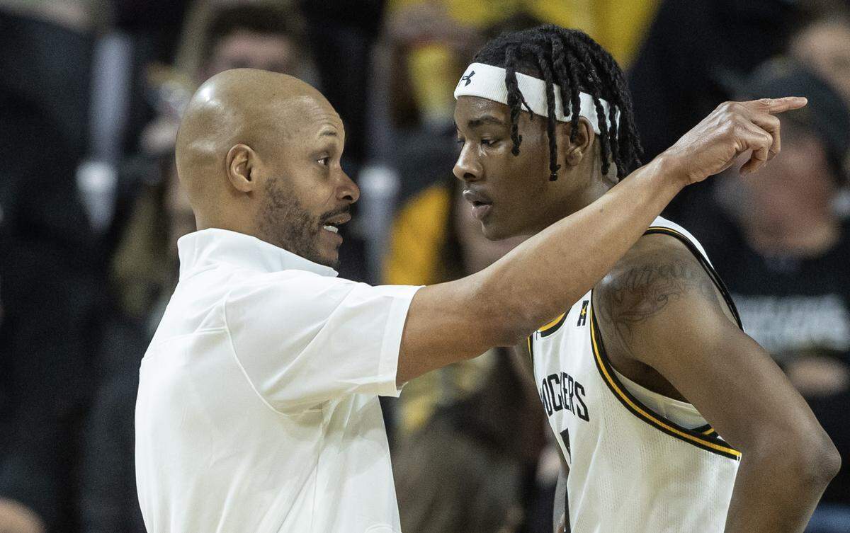 Wichita State coach Isaac Brown gives instructions to Jaron Pierre Jr. during the first half against South Florida on Sunday. It was WIchita State’s final regular season game.