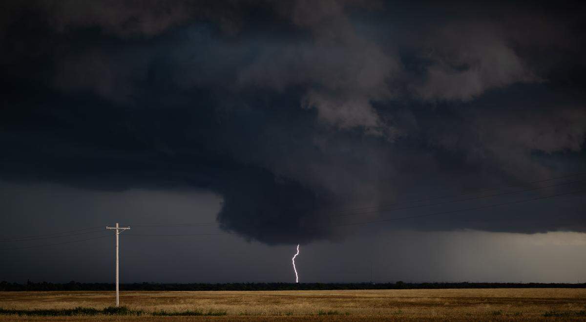 A lightning bolt strikes the ground from a tornado-warned storm near Caldwell in June.