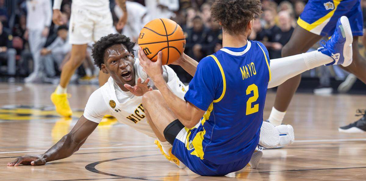 Wichita State’s Quincy Ballard tries to get a loose ball from South Dakota State’s Zeke Mayo during the first half of their game at Intrust Bank Arena on Saturday evening. 