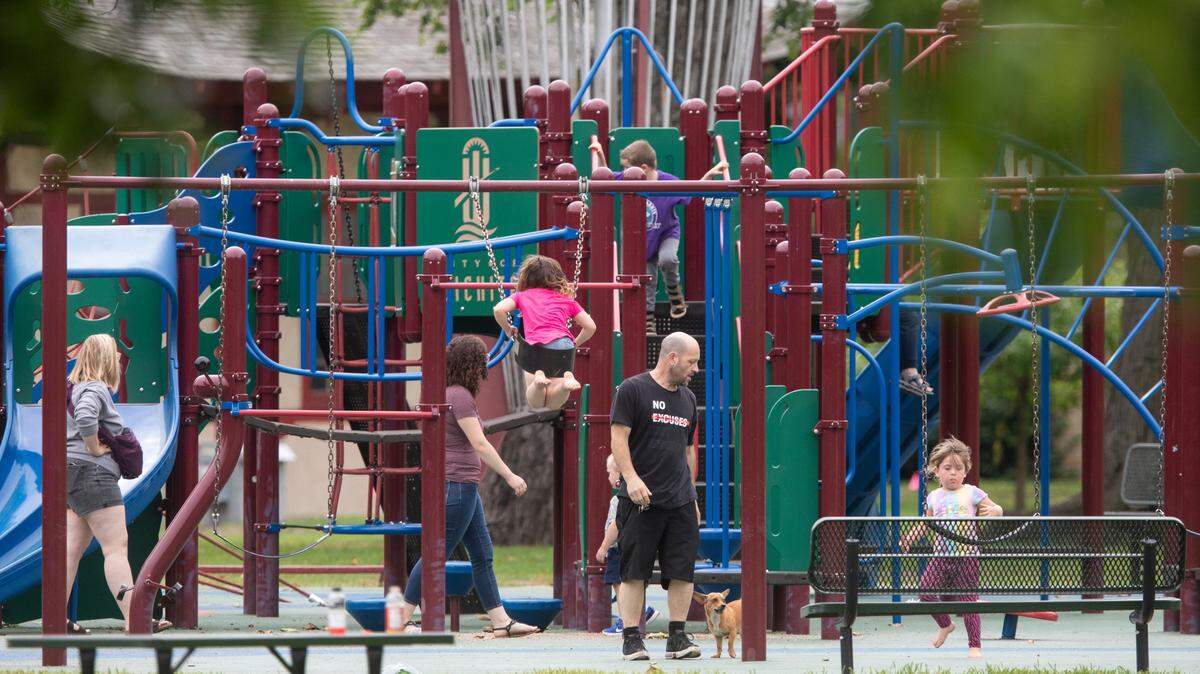 Children play on the playground at Central Riverside Park, one of Wichita’s 146 park properties.